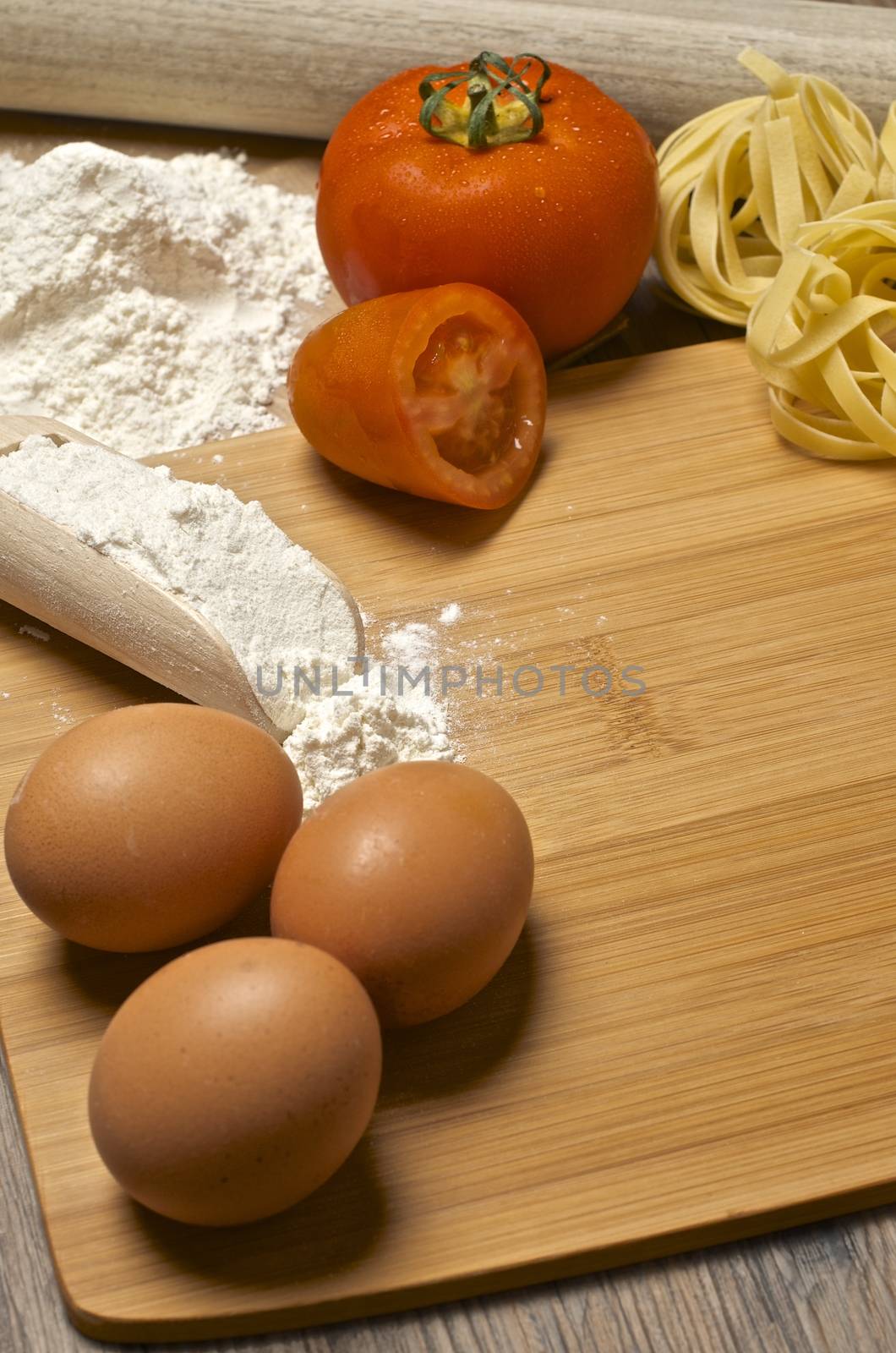 Still life with raw homemade pasta and ingredients for pasta