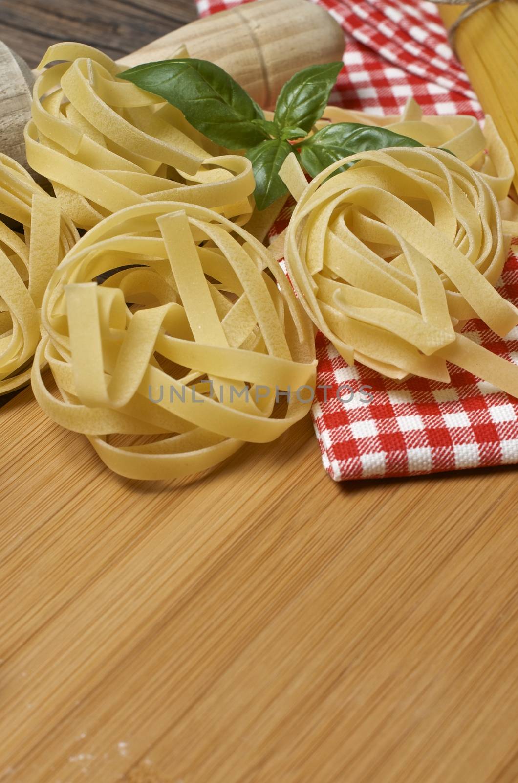 Still life with raw homemade pasta and ingredients for pasta