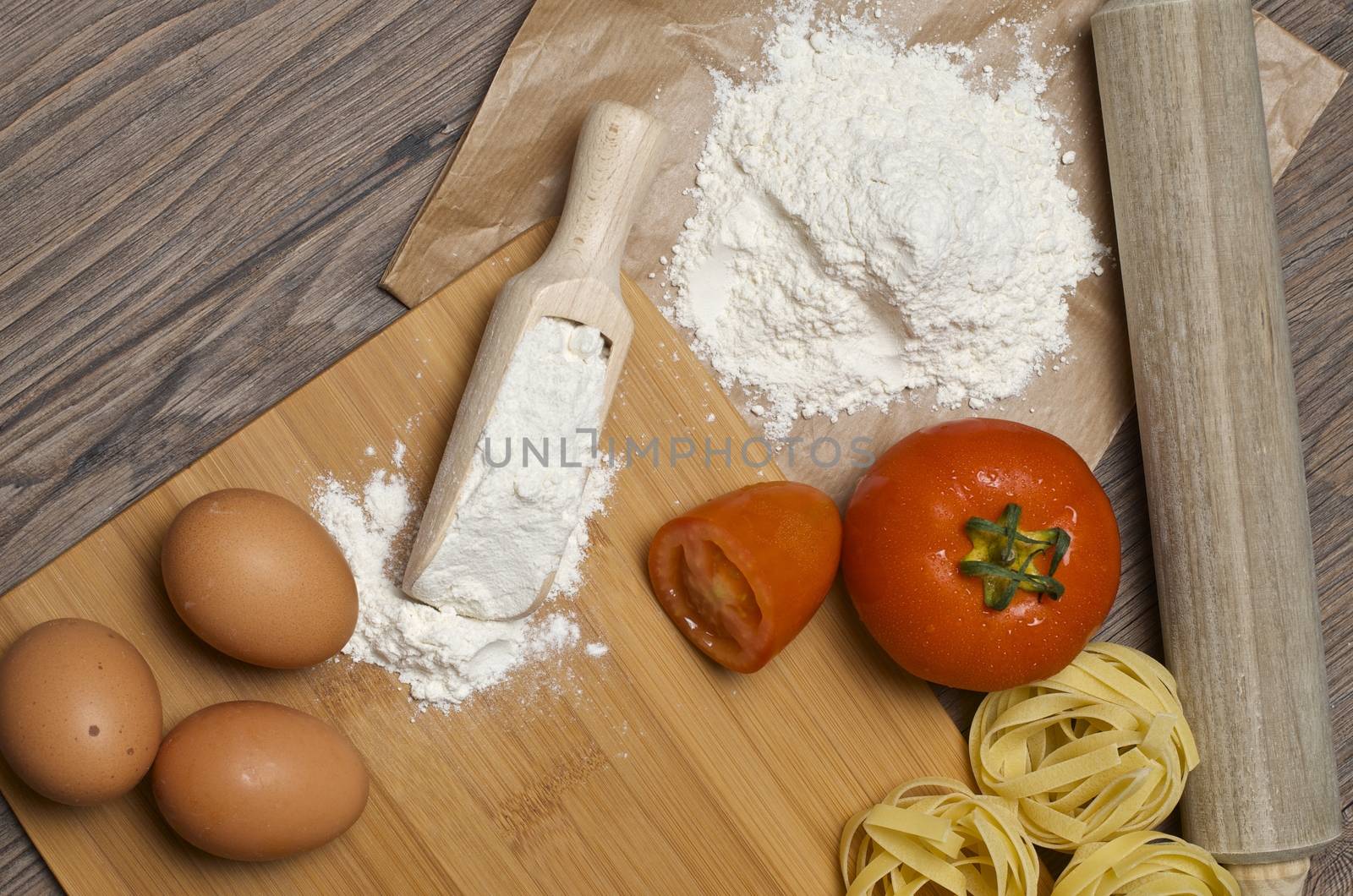 Still life with raw homemade pasta and ingredients for pasta