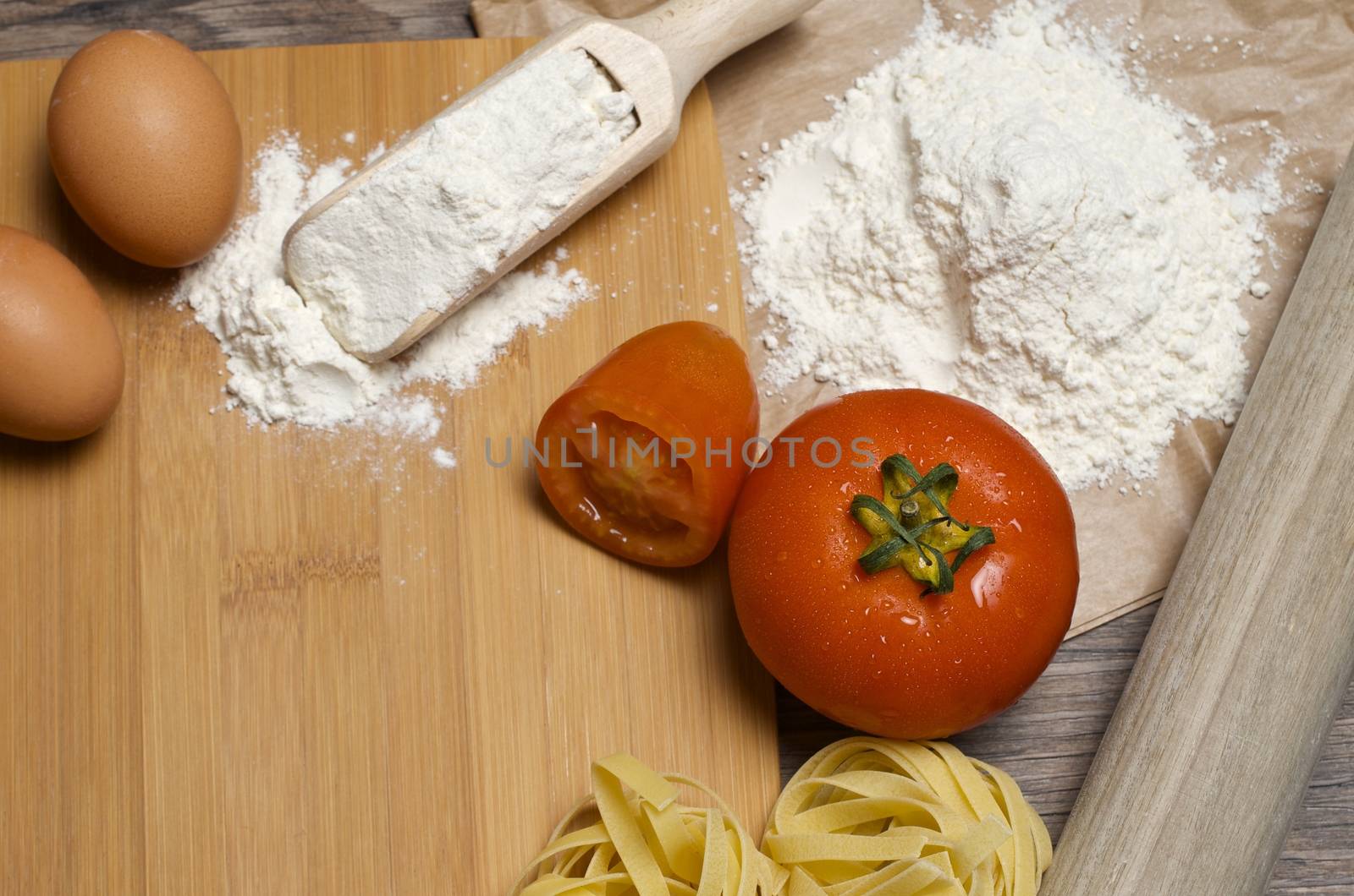 Still life with raw homemade pasta and ingredients for pasta