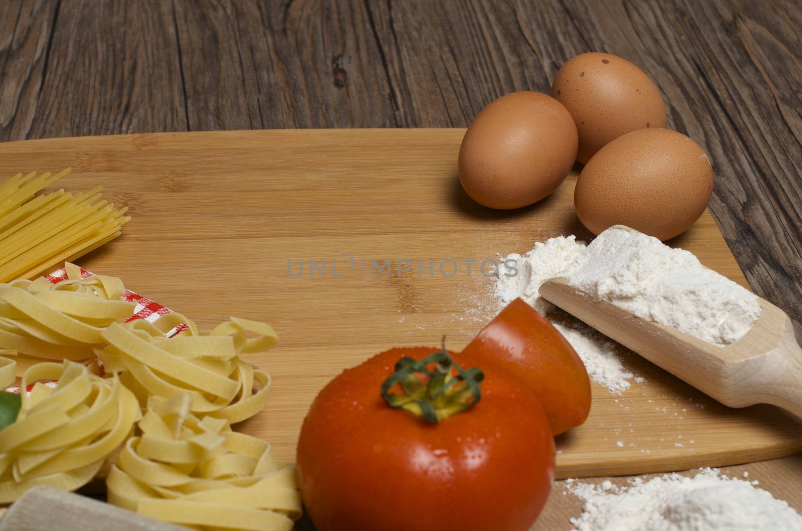 Still life with raw homemade pasta and ingredients for pasta