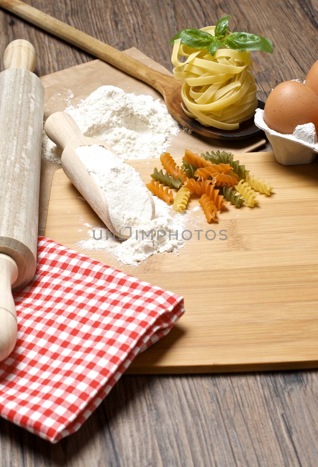 Still life with raw homemade pasta and ingredients for pasta