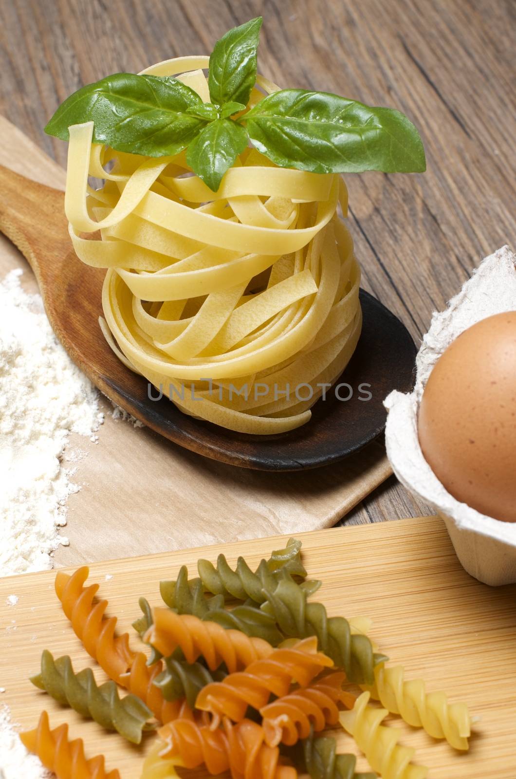 Still life with raw homemade pasta and ingredients for pasta