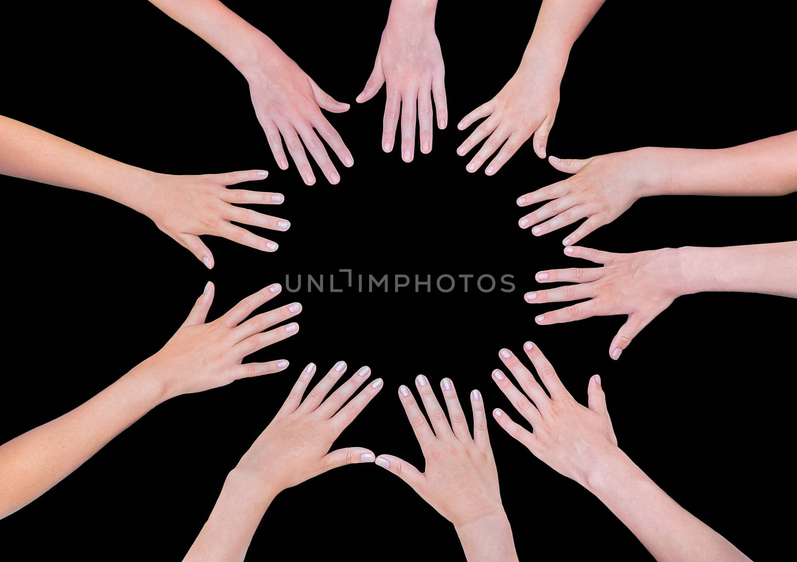 Many teenage girls hands joining in circle isolated on black backgroundf