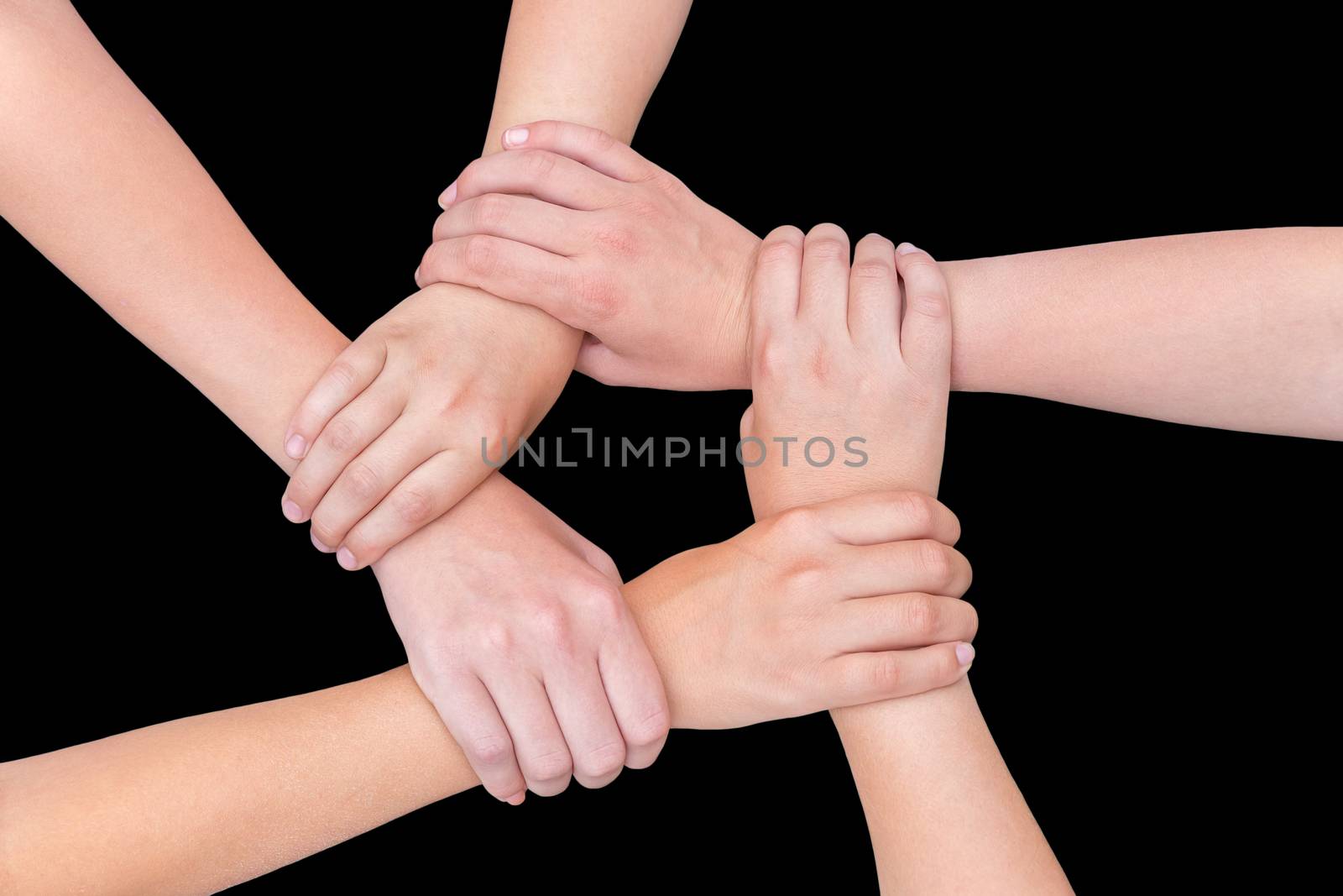 Five arms with hands of girls holding each other joining on black background