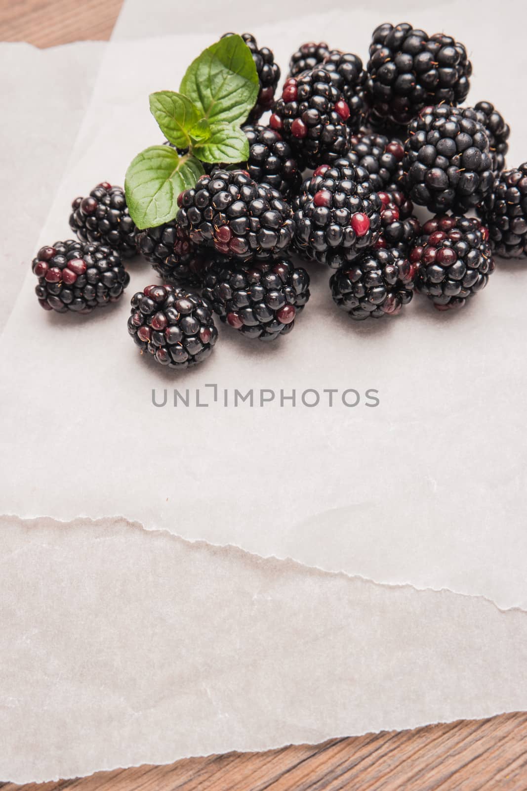 Ripe sweet blackberries on wood table background