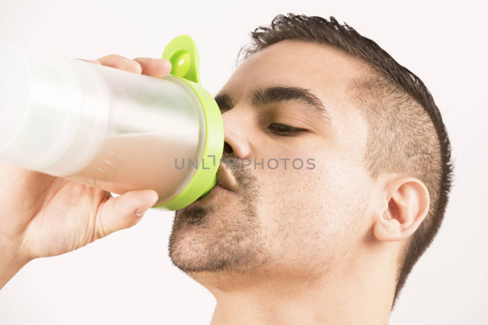 athletic beautiful man with protein shake bottle by CatherineL-Prod