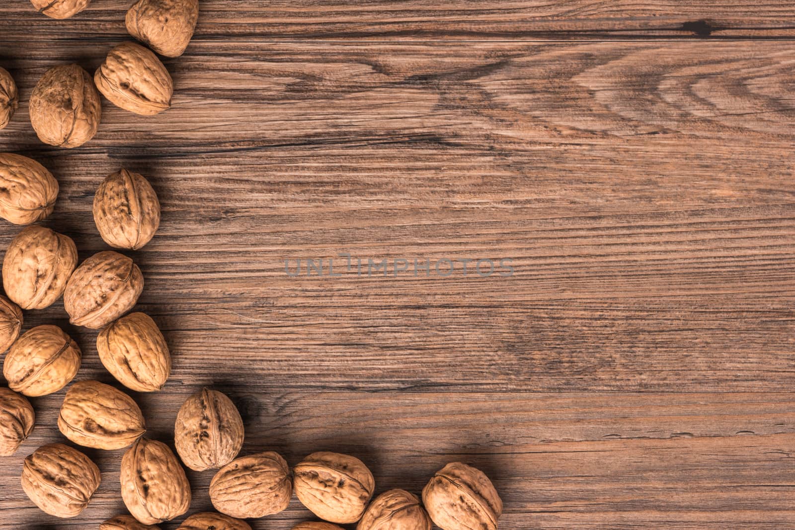 Nuts set background with copyspace on a wood background by AnaMarques