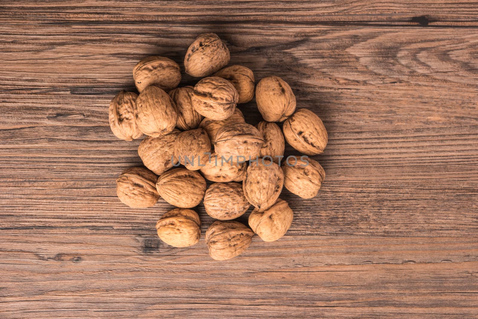 Nuts set background with copyspace on a wood background. Top view with copy space