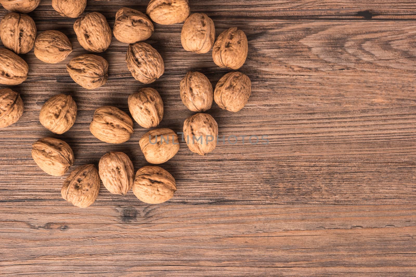 Nuts set background with copyspace on a wood background. Top view with copy space