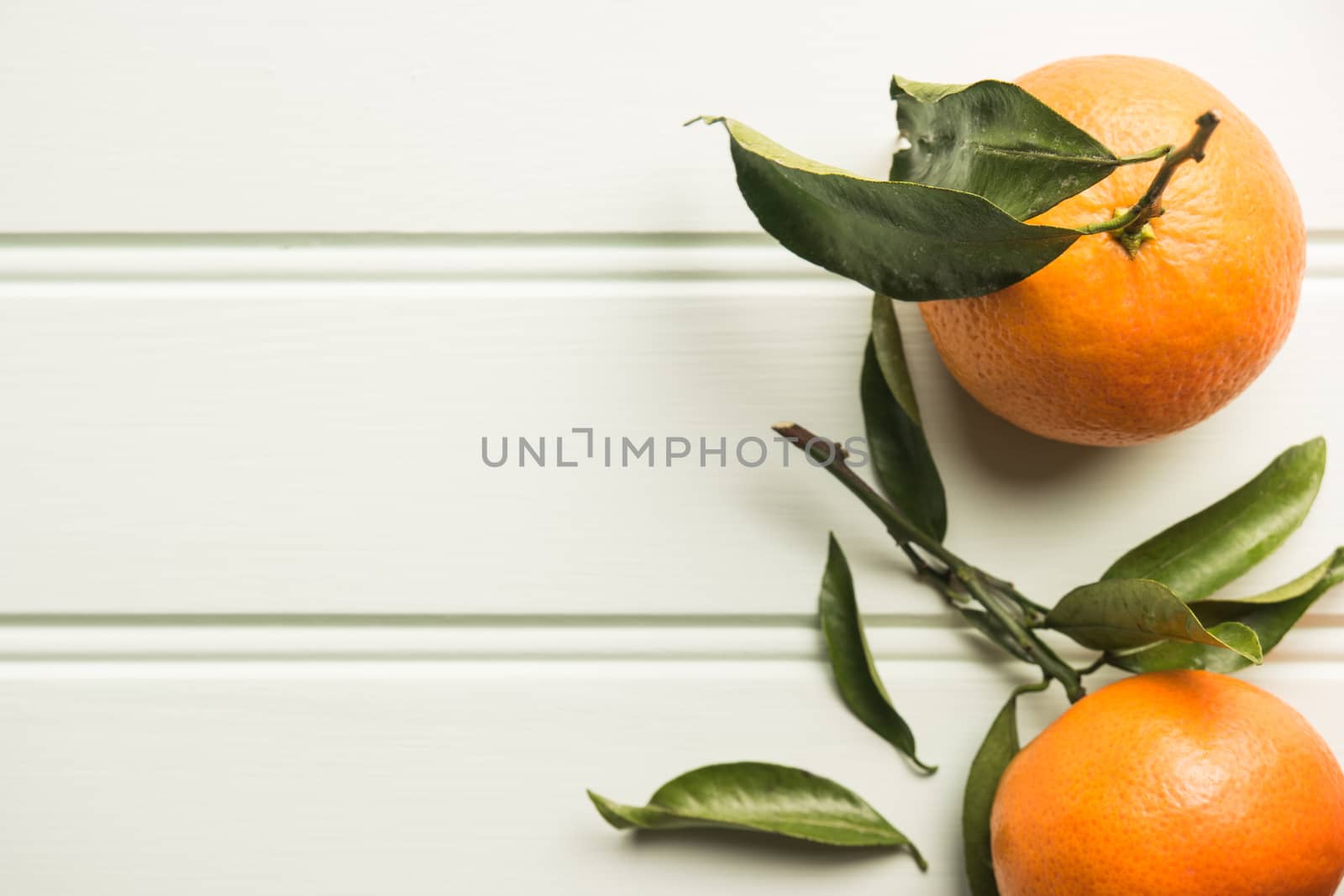 Natural sweet clementines on rustic table from above by AnaMarques