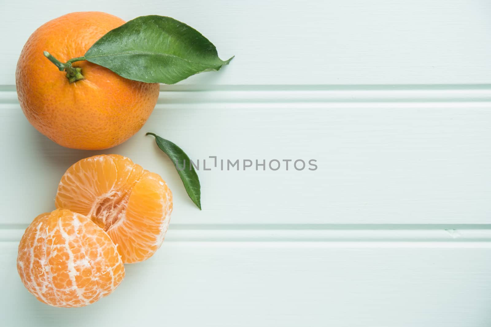 Natural sweet clementines on rustic table from above by AnaMarques
