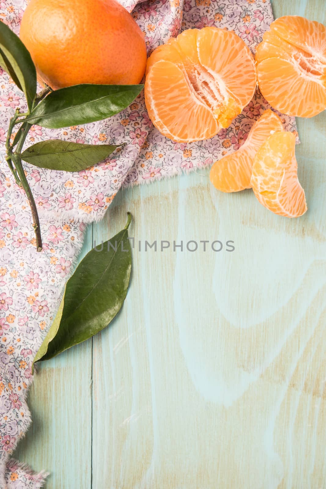 Natural sweet clementines on rustic table from above by AnaMarques