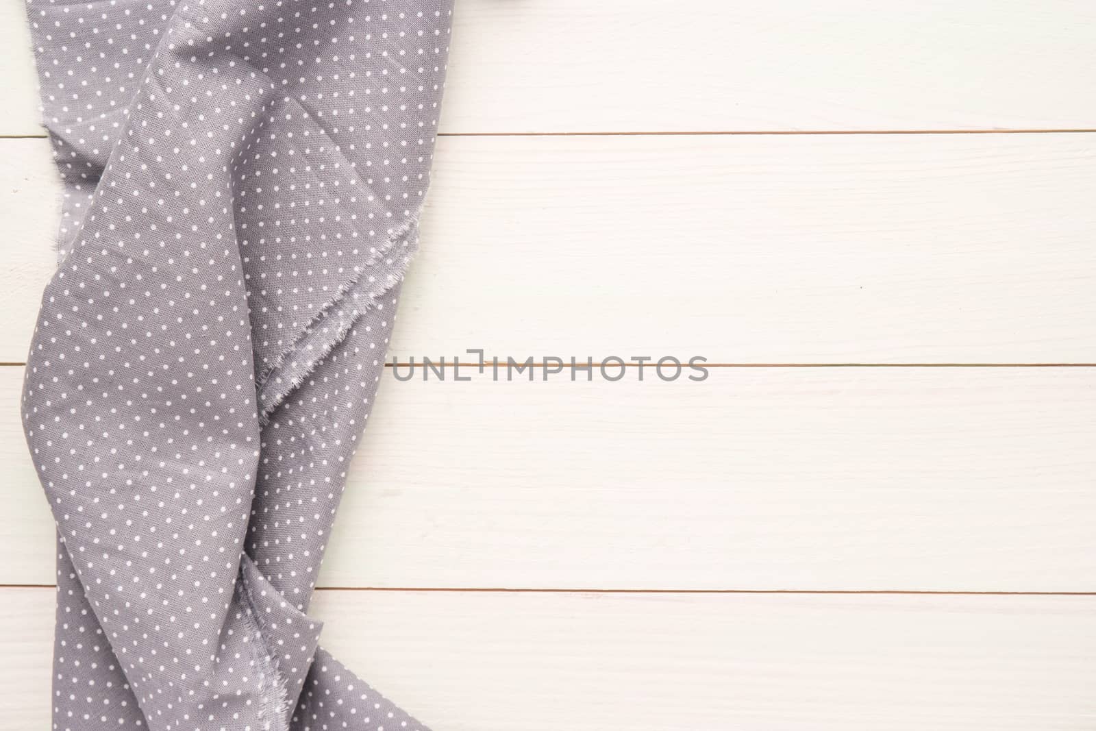 Polka dot fabric over wooden kitchen table. by AnaMarques