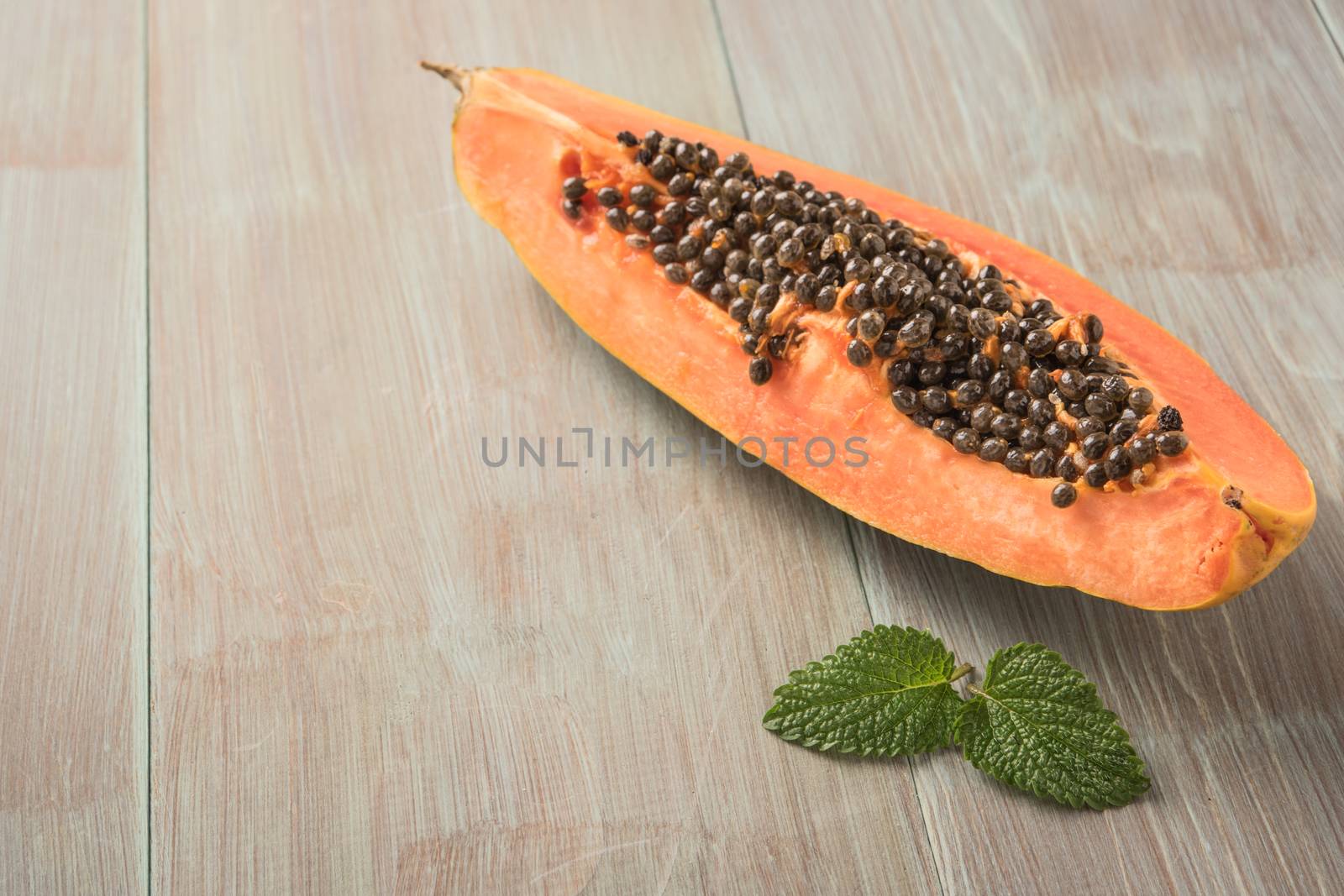 Sliced fresh papaya on wooden background. Top view with copy space