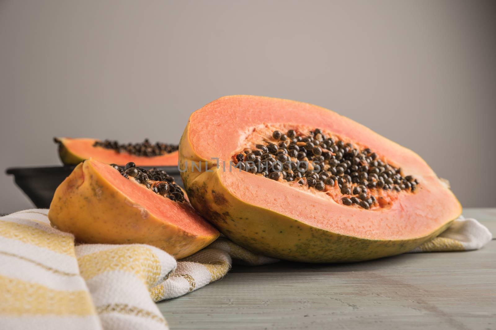Sliced fresh papaya on wooden background. Top view with copy space