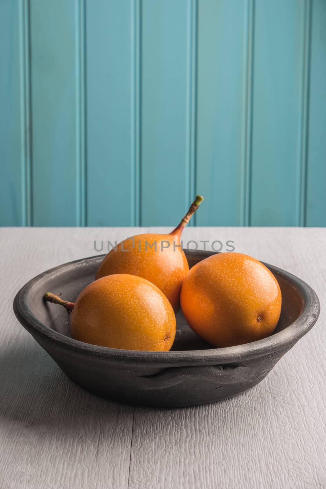 Fresh granadillas on wooden board