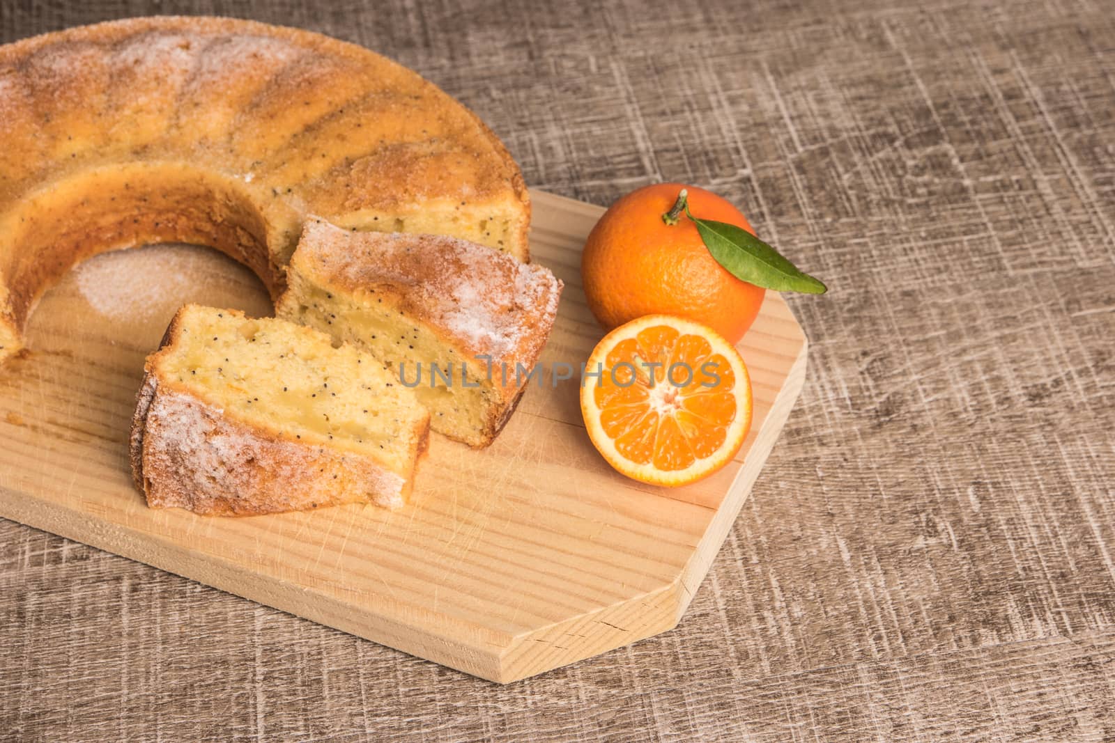 Slices of clementine cake with powdered sugar topping. Cake on a by AnaMarques