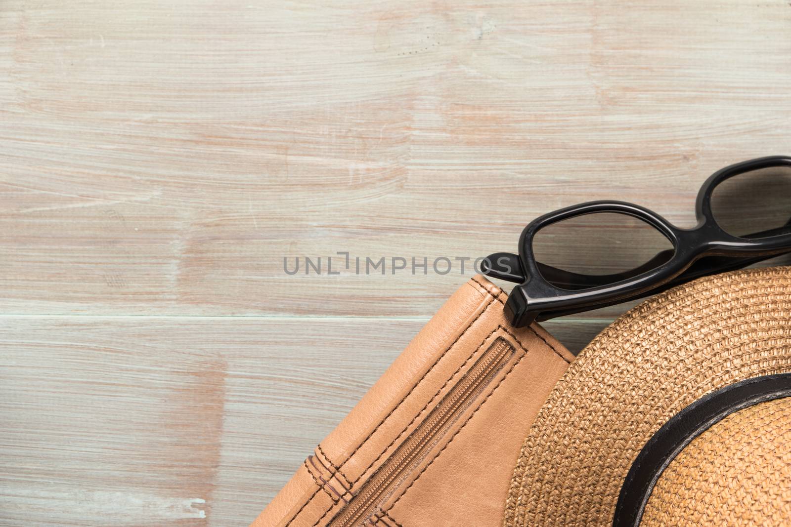 Travel, summer vacation, tourism and objects concept - close up of hat, wallet, sunglasses and scarf on wooden table. Top view with copy space.