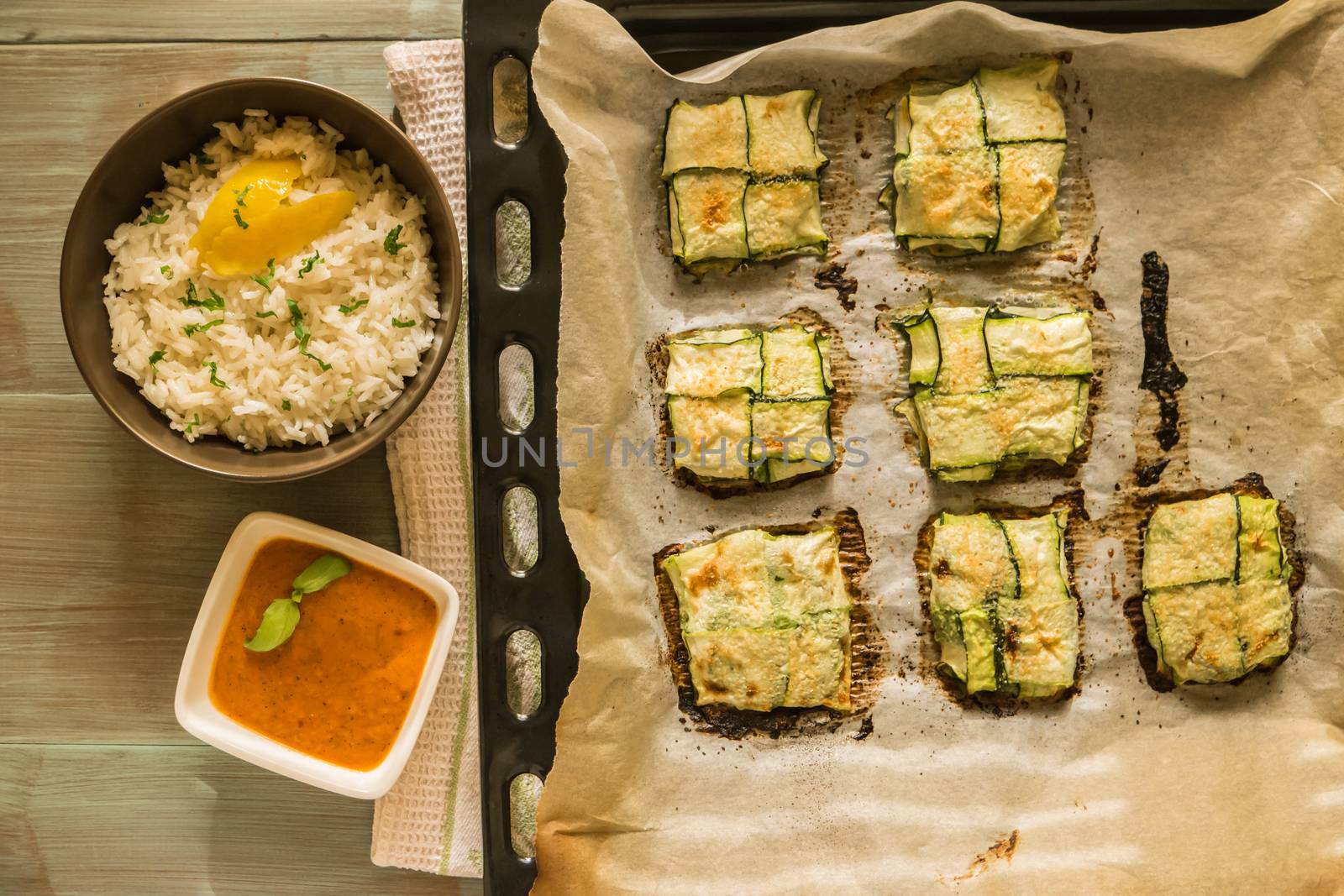 Oven baked courgettes stuffed with cheese, garlic and herbs. Courgette recipe in the oven. Top view with copy space.