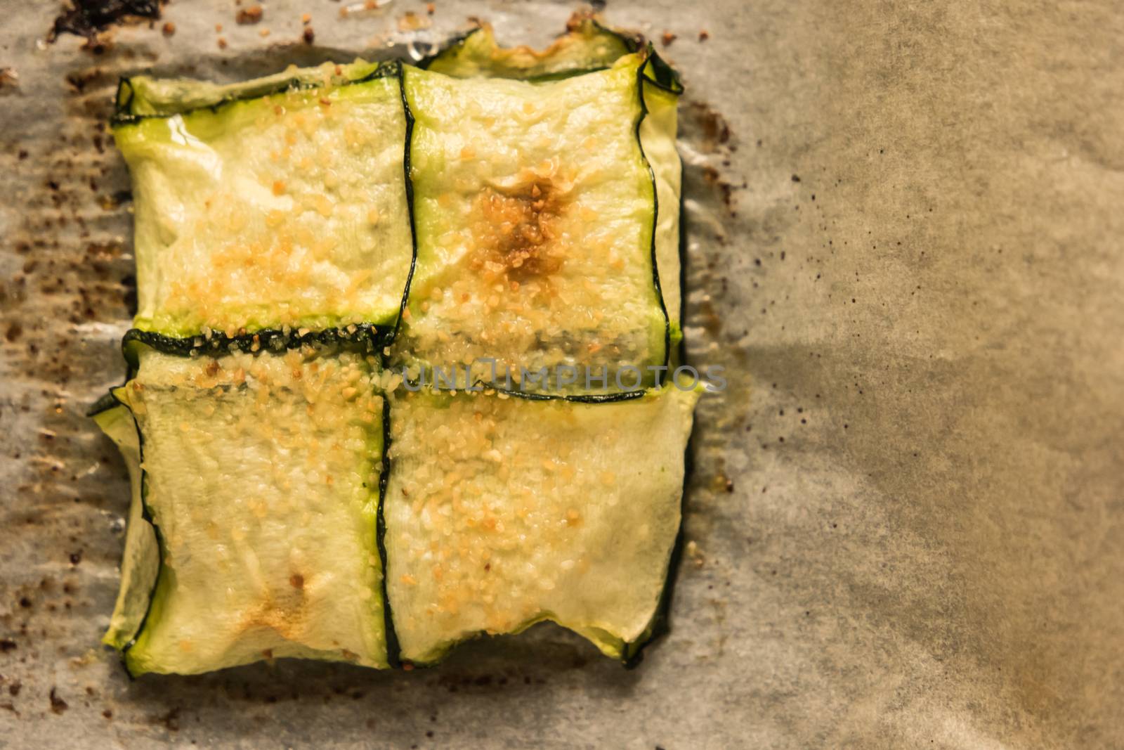 Oven baked courgettes stuffed with cheese, garlic and herbs. Courgette recipe in the oven. Top view with copy space.