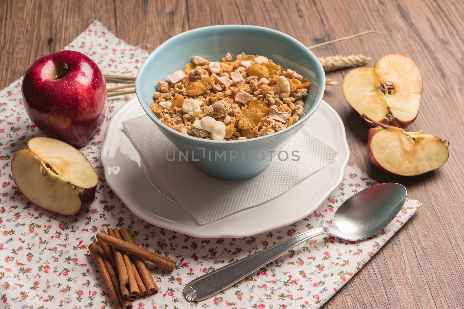 Healthy breakfast with muesli, red apple and cinnamon on rustic by AnaMarques