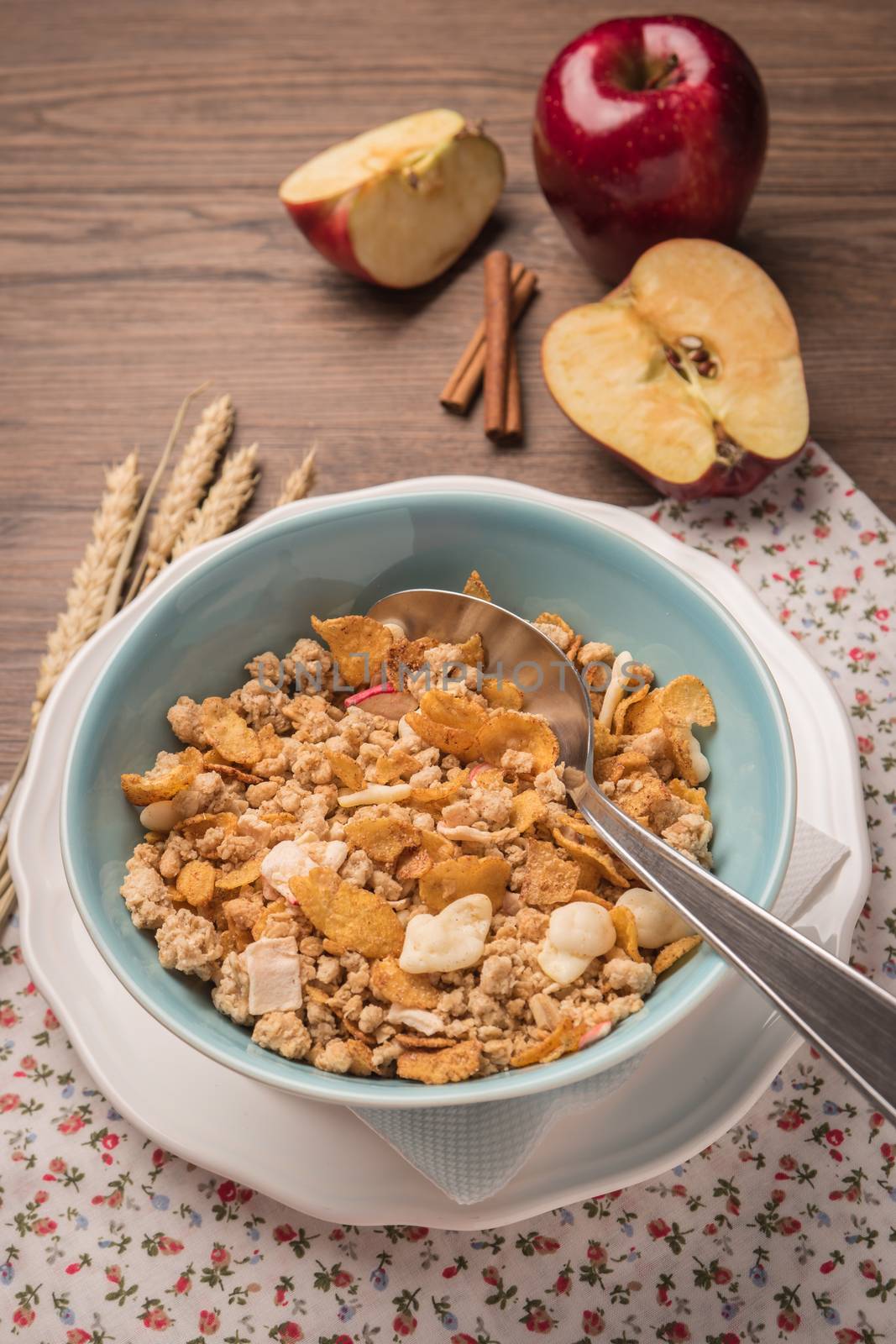 Healthy breakfast with muesli, red apple and cinnamon on rustic  by AnaMarques