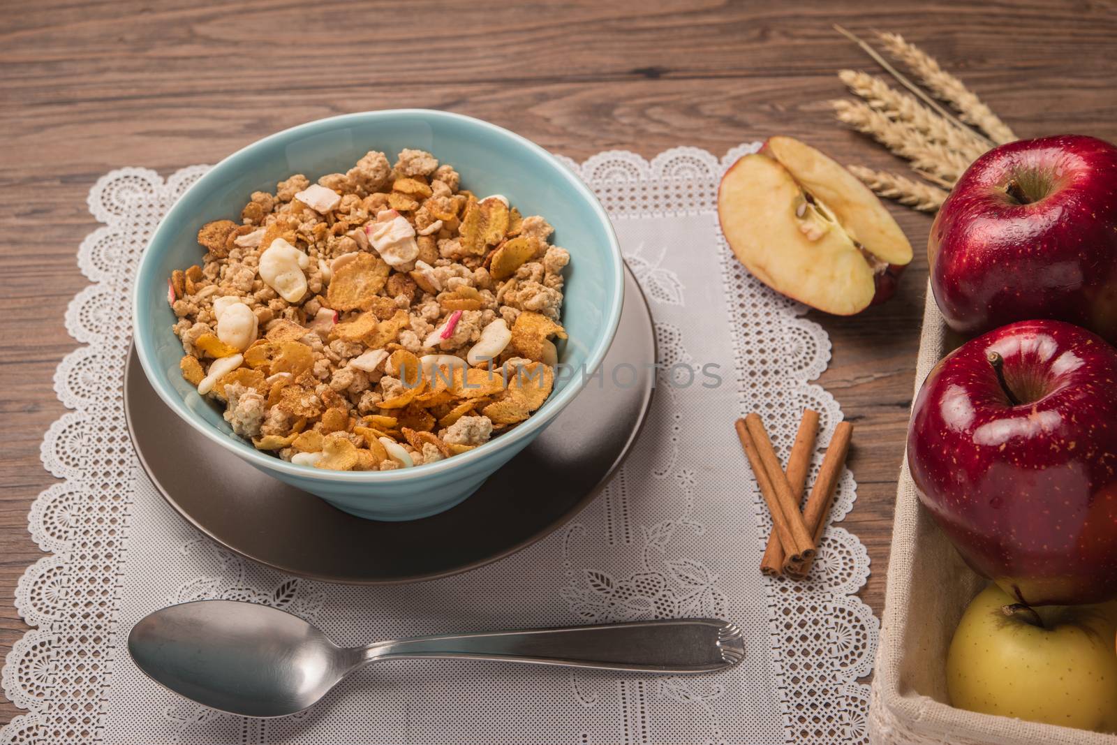 Healthy breakfast with muesli, red apple and cinnamon on rustic  by AnaMarques