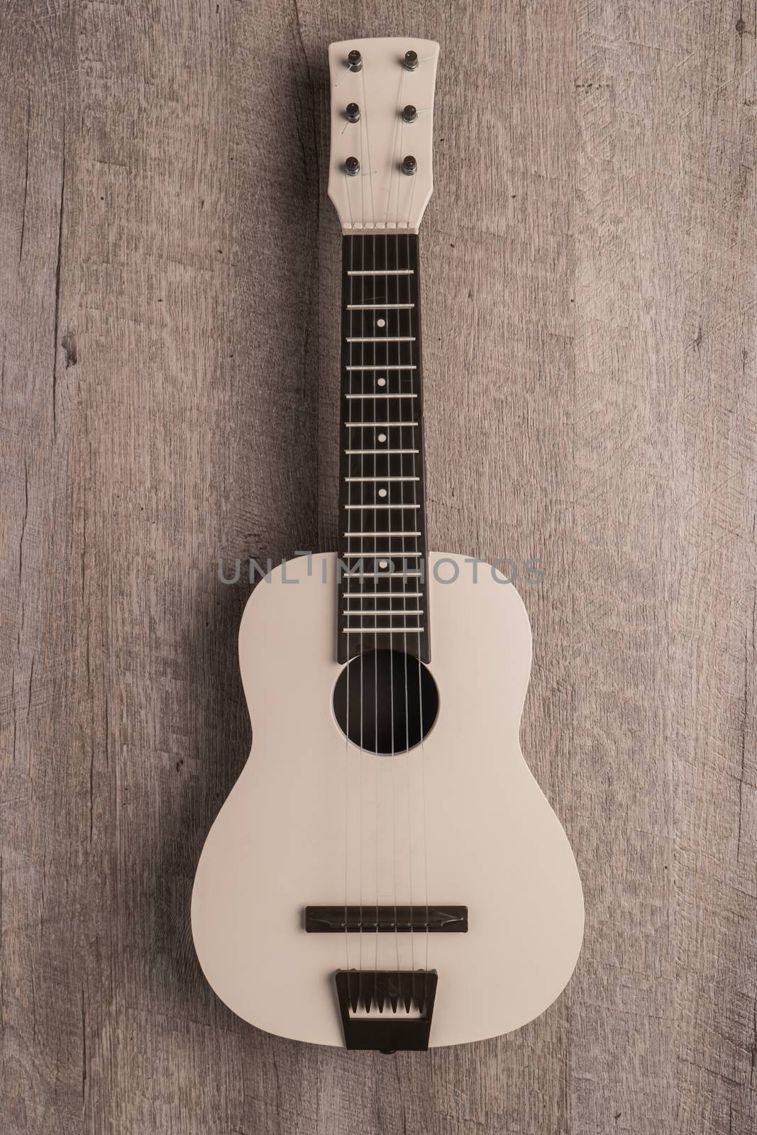 Guitar on rustic wooden background texture. Top view with copy space