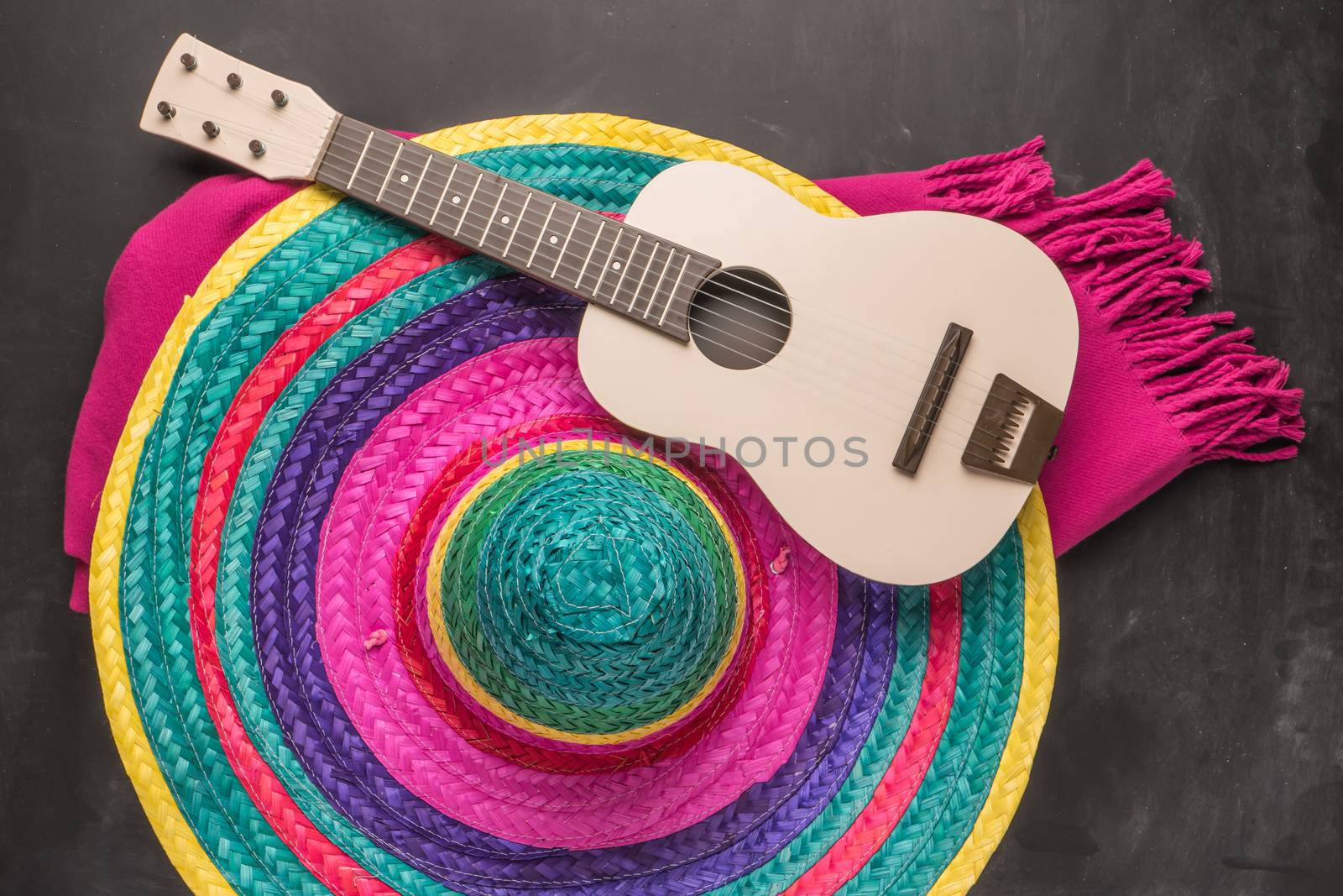 Mexican background. Sombrero, guitar and blankets on rustic slate background. Top view with copy space