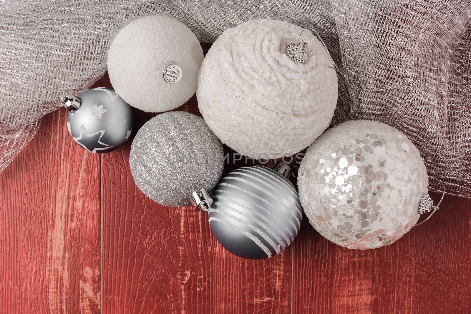 Festive glitter christmas balls decorations on rustic wooden table. Seasonal winter holidays. Top view with copy space