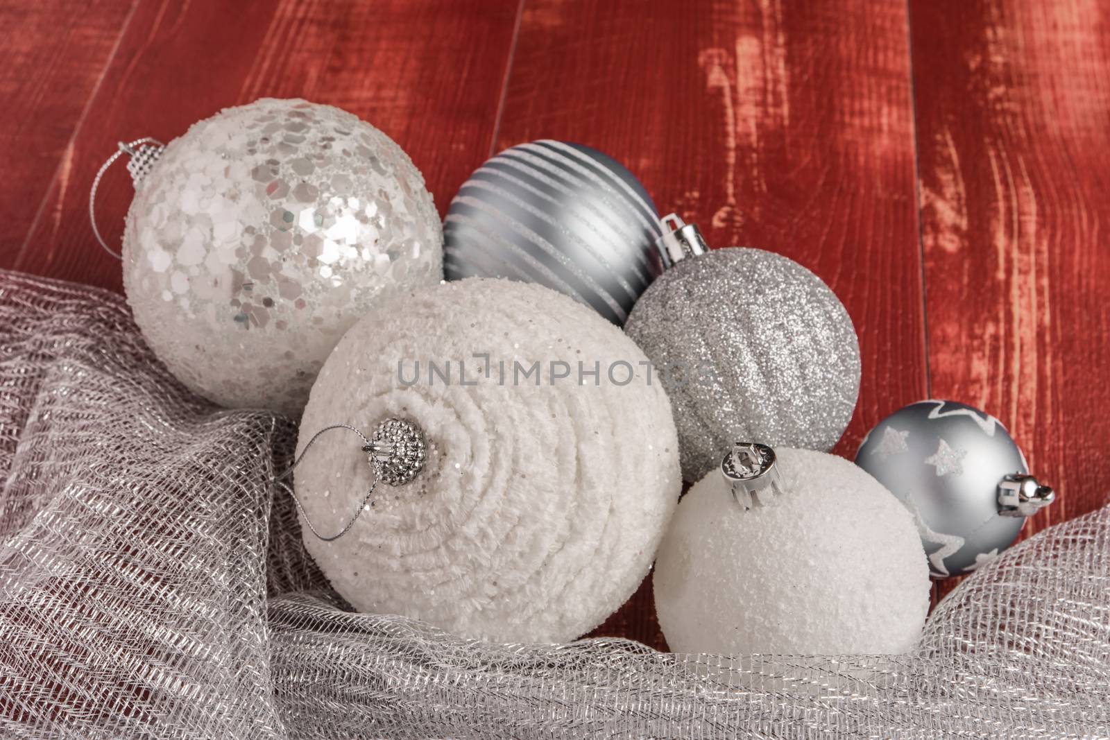 Festive glitter christmas balls decorations on rustic wooden table. Seasonal winter holidays. Top view with copy space