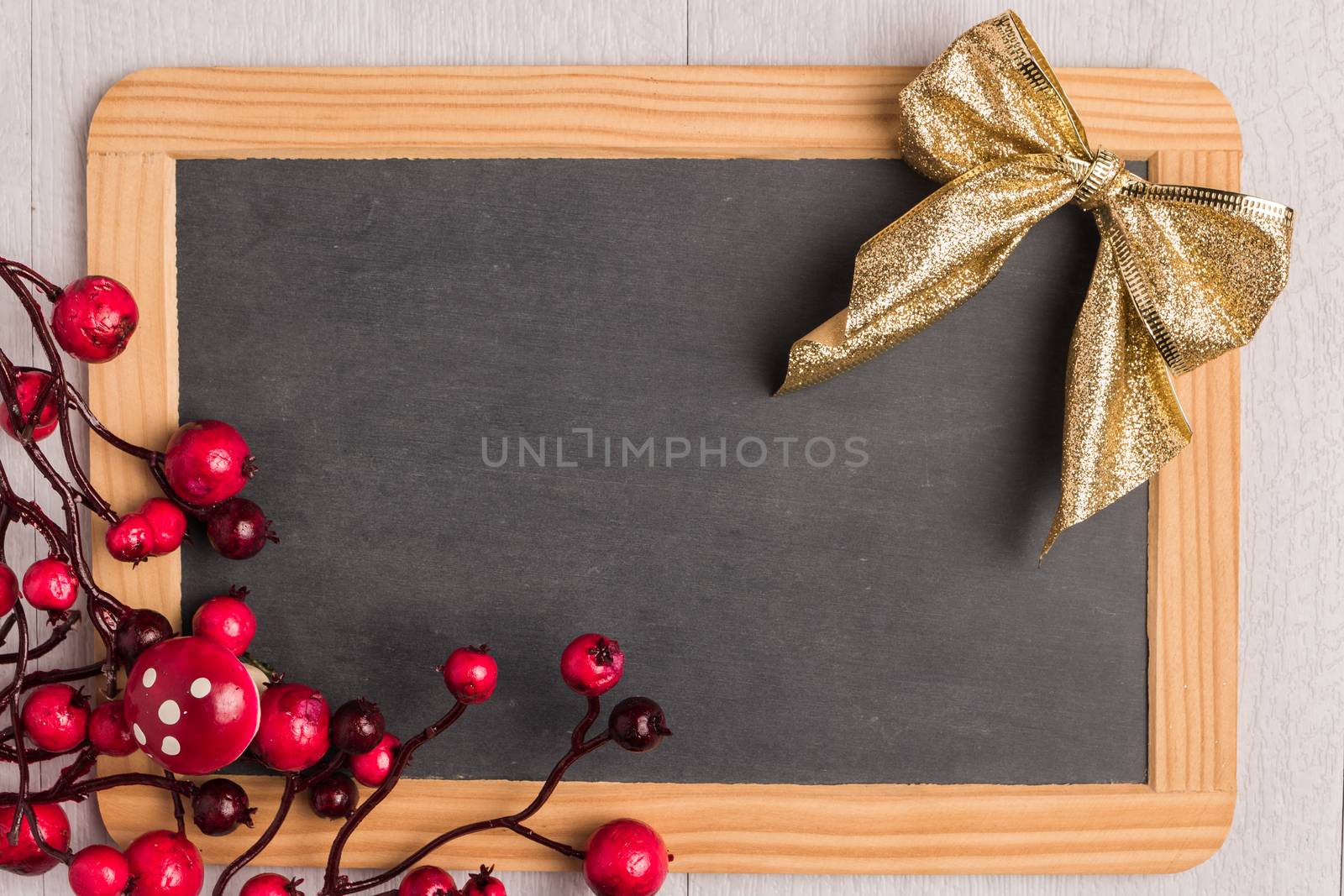 Blank rustic Christmas chalkboard slate with lace ready for your seasonal greetings. Top view with copy space 