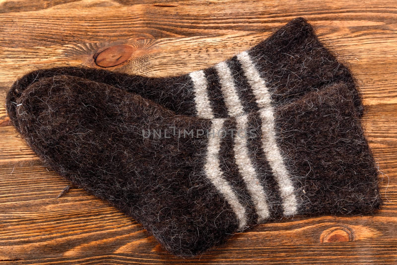 Knitted wool socks on a brown wooden background