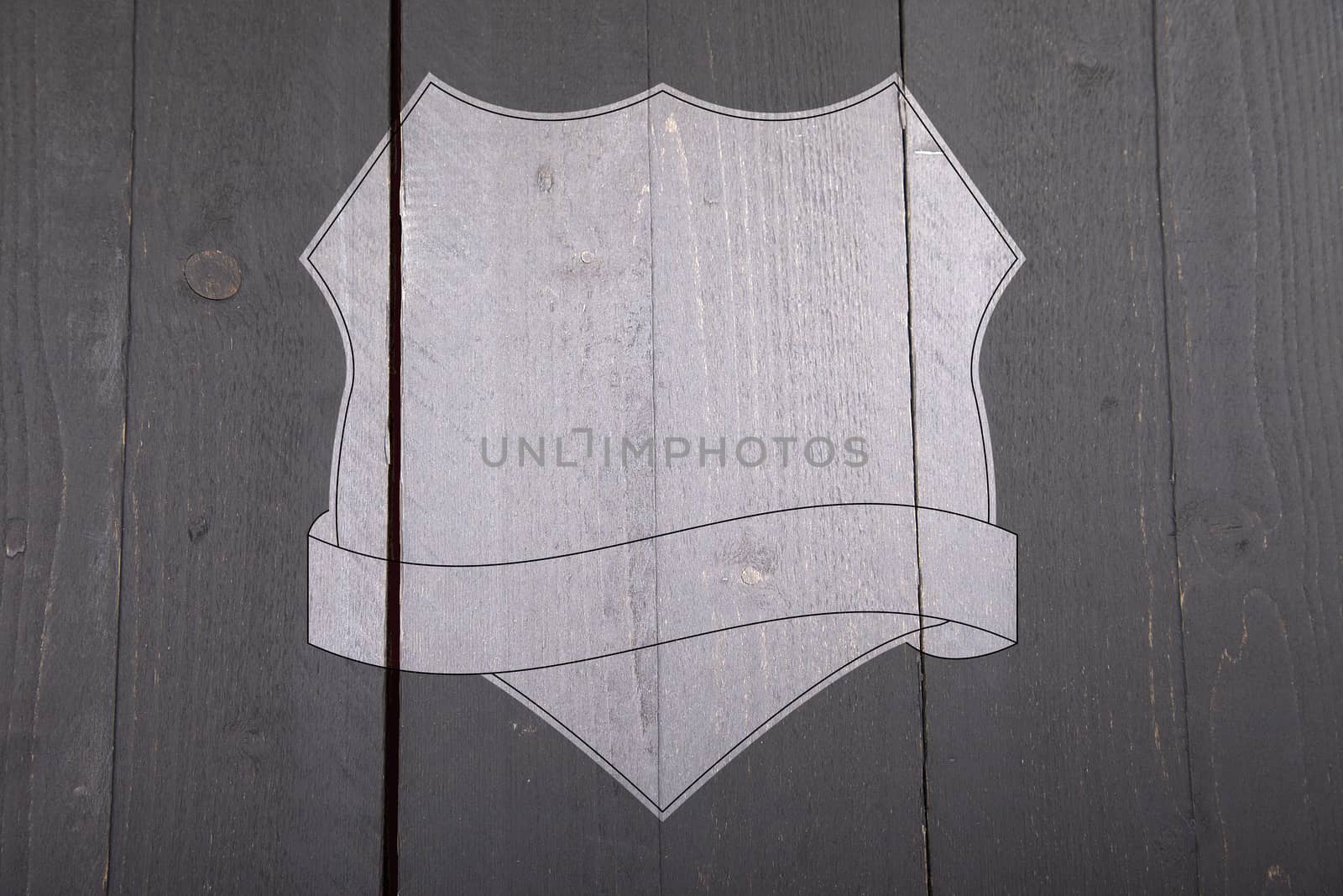 White shield on black wooden background by gigra