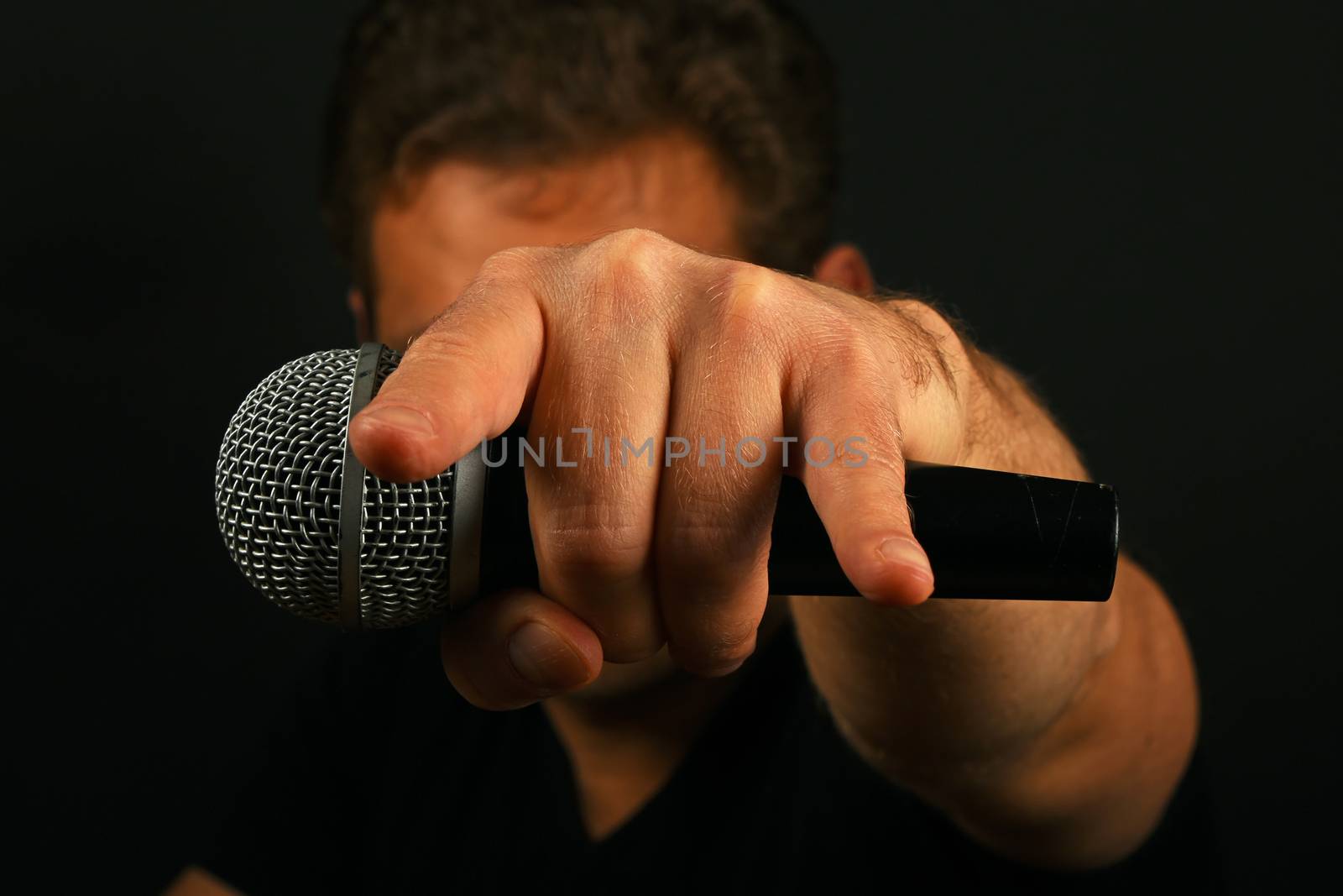 Hand with microphone and devil horns on black by BreakingTheWalls