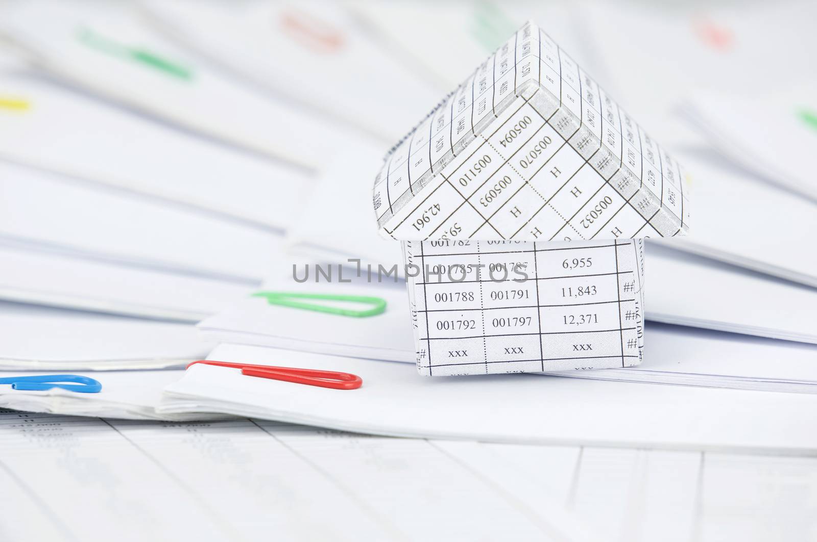 Close up house with step of paperwork with colorful paperclip place curve on finance account.