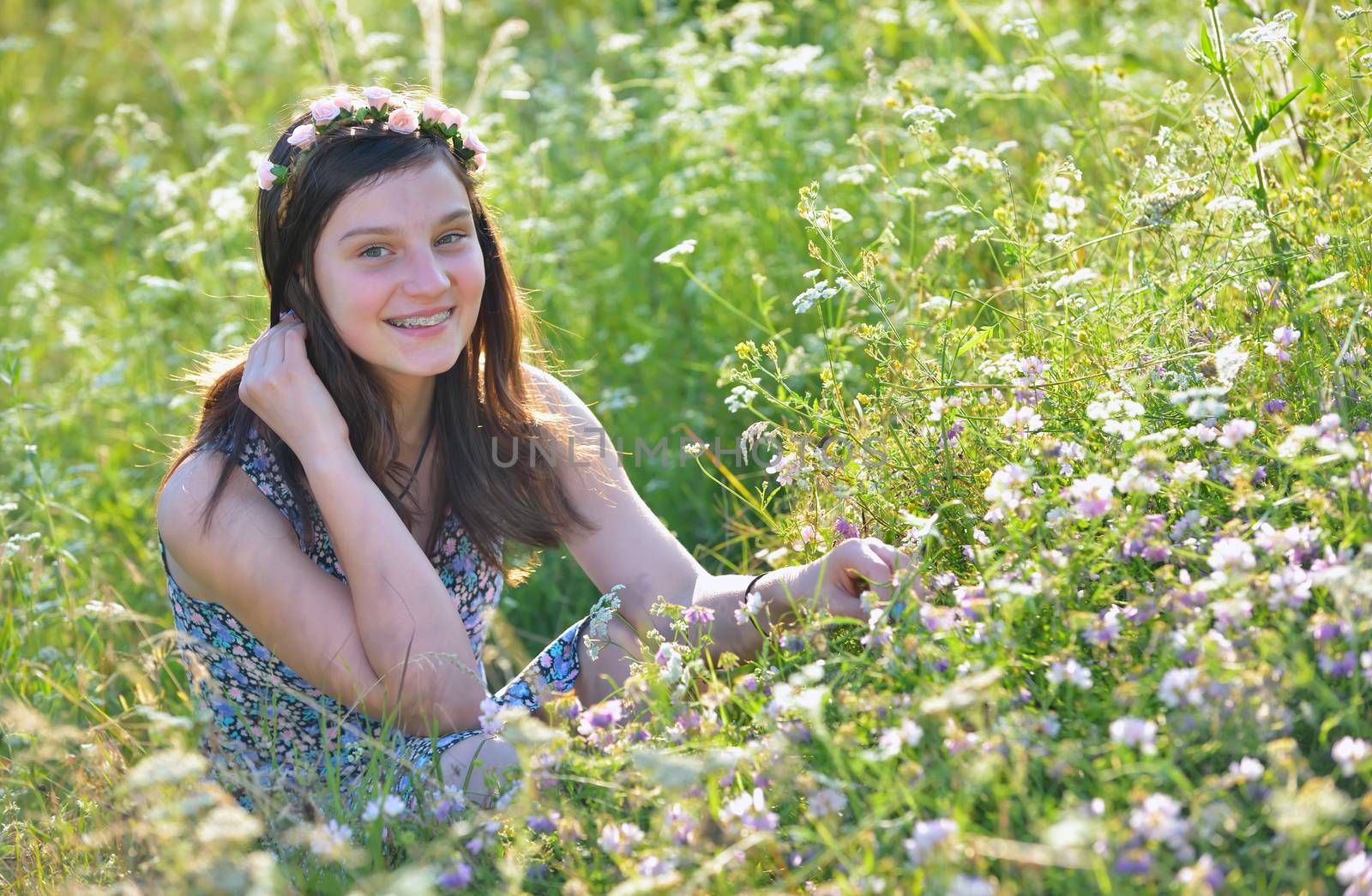 Teen girl in a summer field 