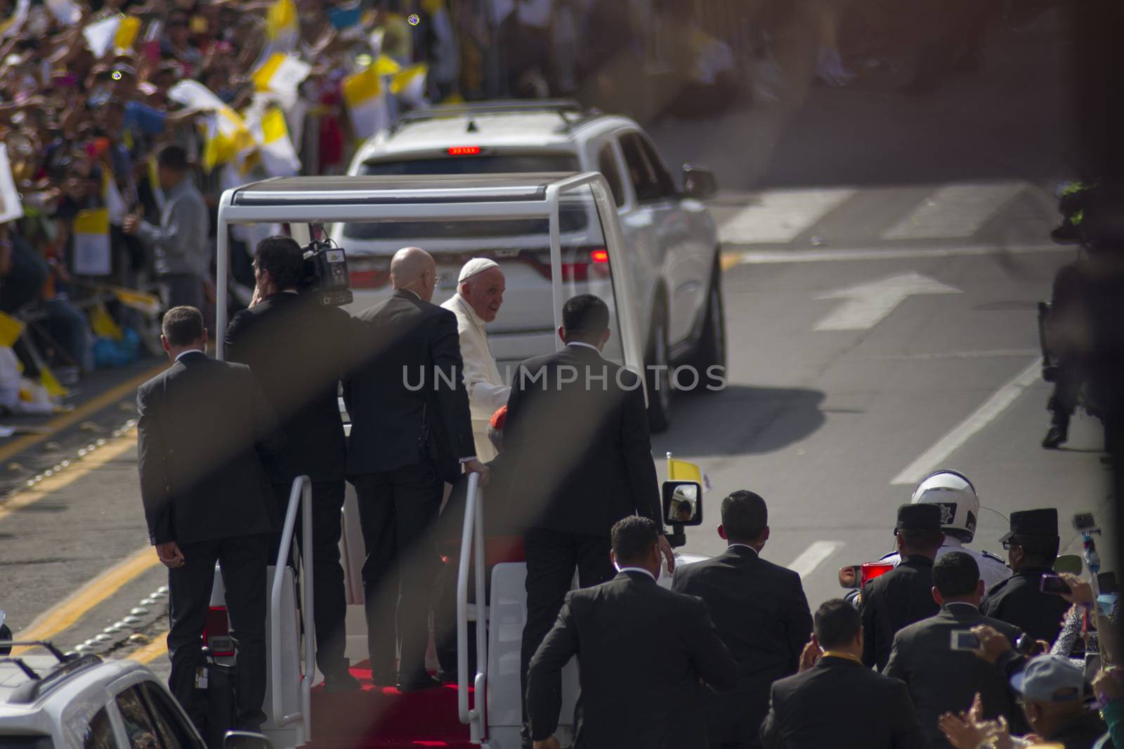 MEXICO, Morelia : Pope Francis waves to the faithful upon his arrival in Morelia, Michoacán, on February 16, 2016. Pope Francis arrived in Mexico's troublesome western state of Michoacan, where the cult-like Knights Templar drug cartel and its pseudo-messianic leader terrorized the population until farmers revolted against them.   