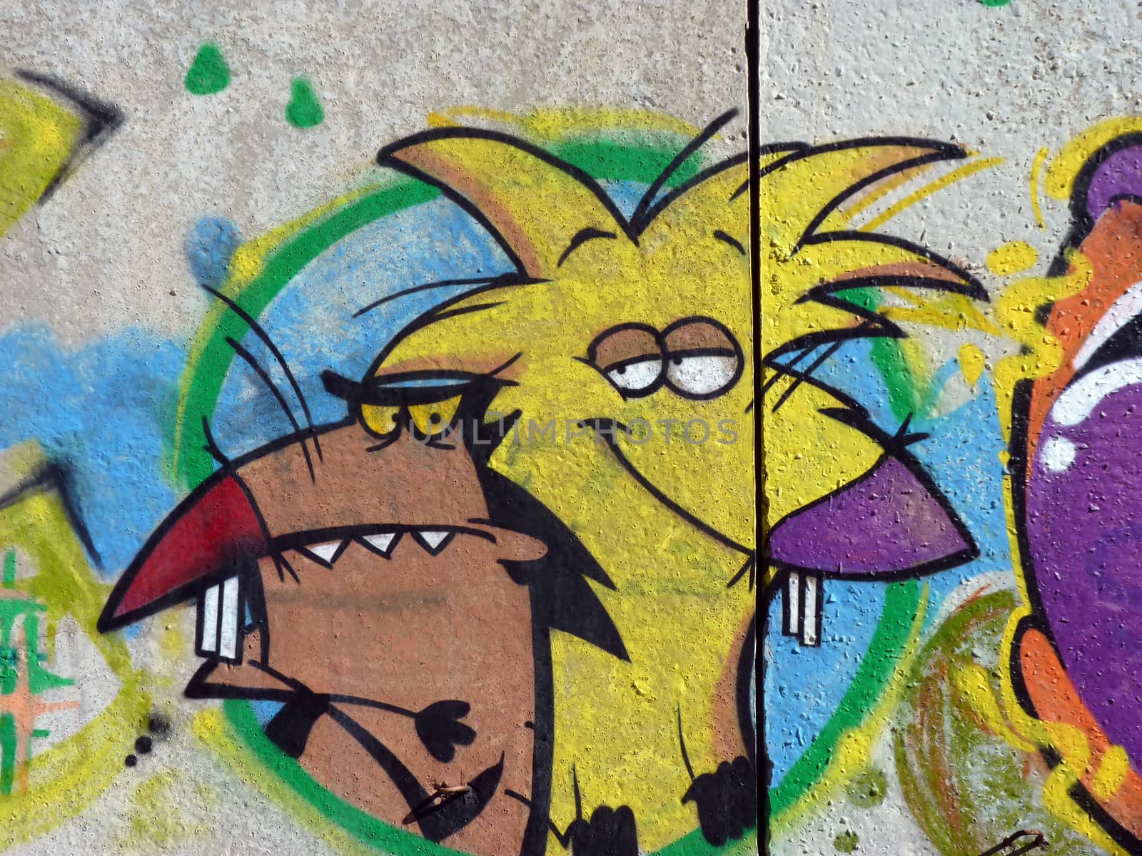 Graffiti cheerful rodents on a concrete wall in the city of Volgograd