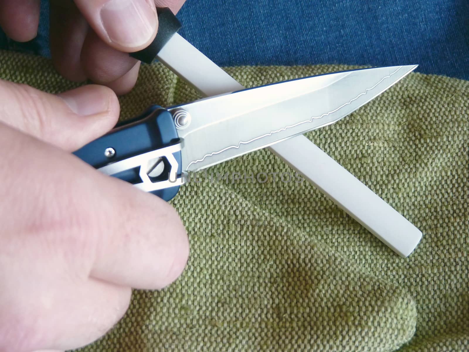Sharpening of a small penknife on a ceramic musat