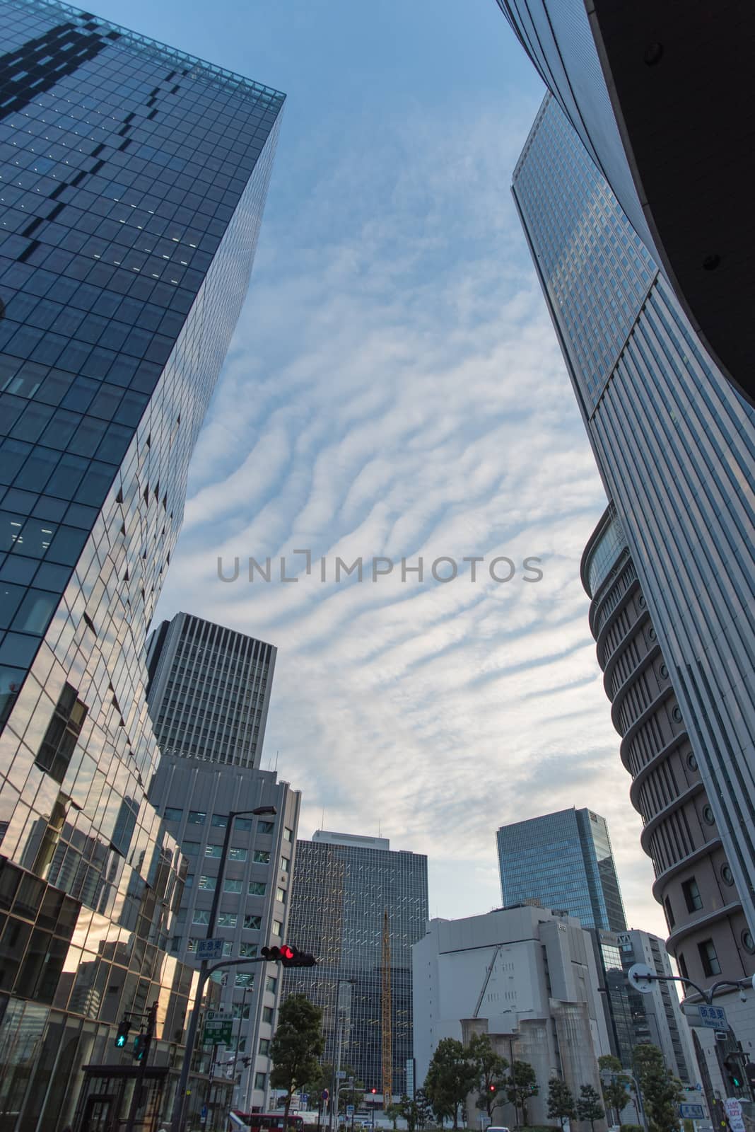 Osaka, Japan - November 4 : Upside view of office building in blue sky wave pattern