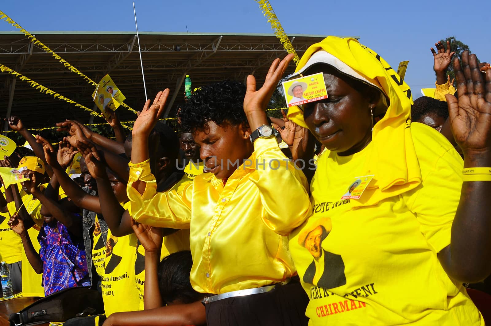 UGANDA, Kampala : Supporters of Uganda's incumbent leader and presidential candidate Yoweri Museveni pray during his last electoral rally at Kololo Airstrip in Kampala on February 16, 2016.Uganda's presidential contenders held their final campaign rallies on February 16, a day after opposition supporters clashed with police leaving at least one person dead. Museveni and his ruling National Resistance Movement (NRM) party is widely predicted to win a fifth term in power in polls, and warned at a rally against voting for his rivals. 