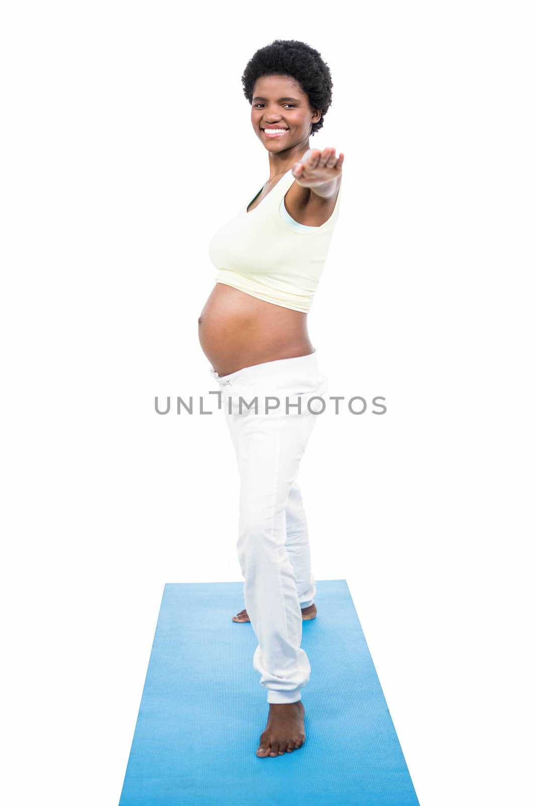 Pregnant woman doing yoga exercise by Wavebreakmedia