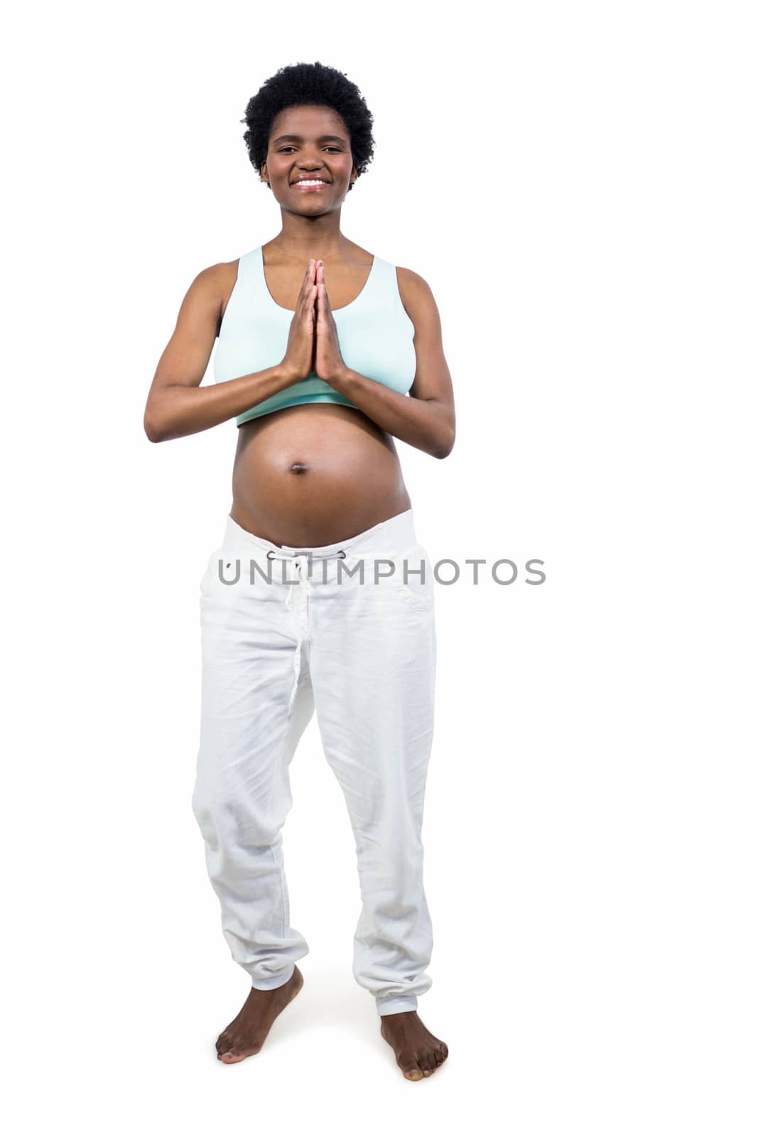 Pregnant woman doing yoga exercise on white background
