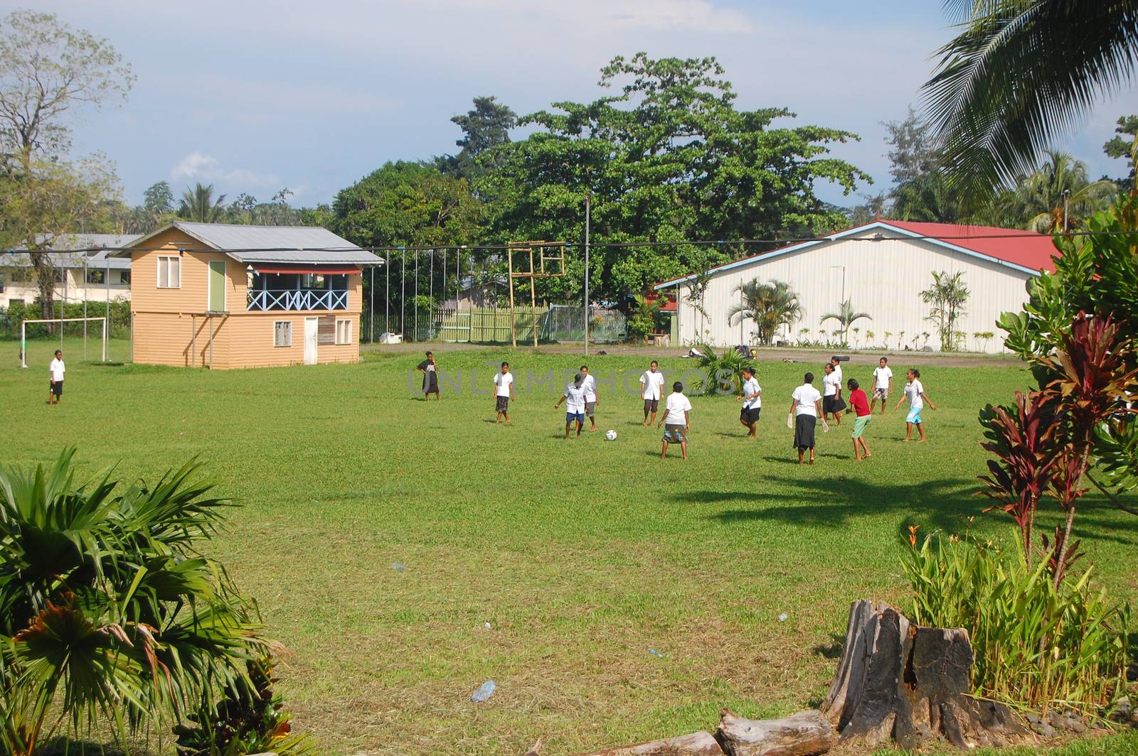 Women play soccer at high school campus by danemo