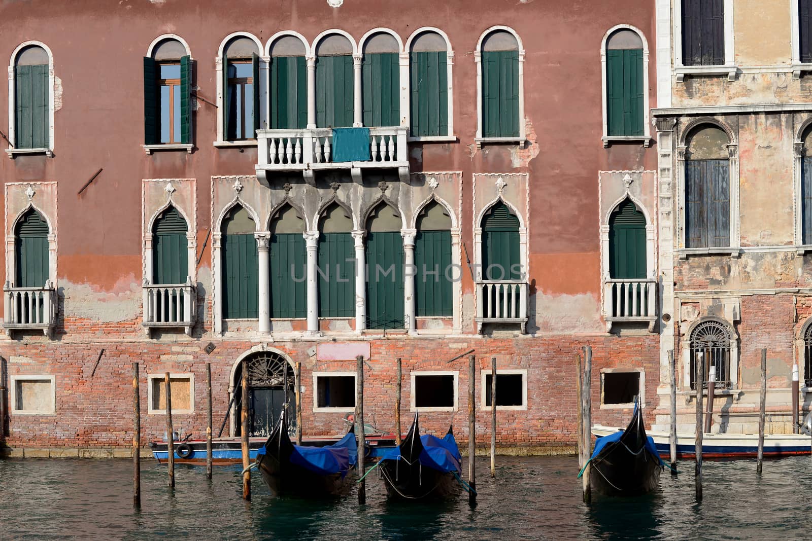 Gondolas floating on Canal with traditional building in the background, Venice, Italy