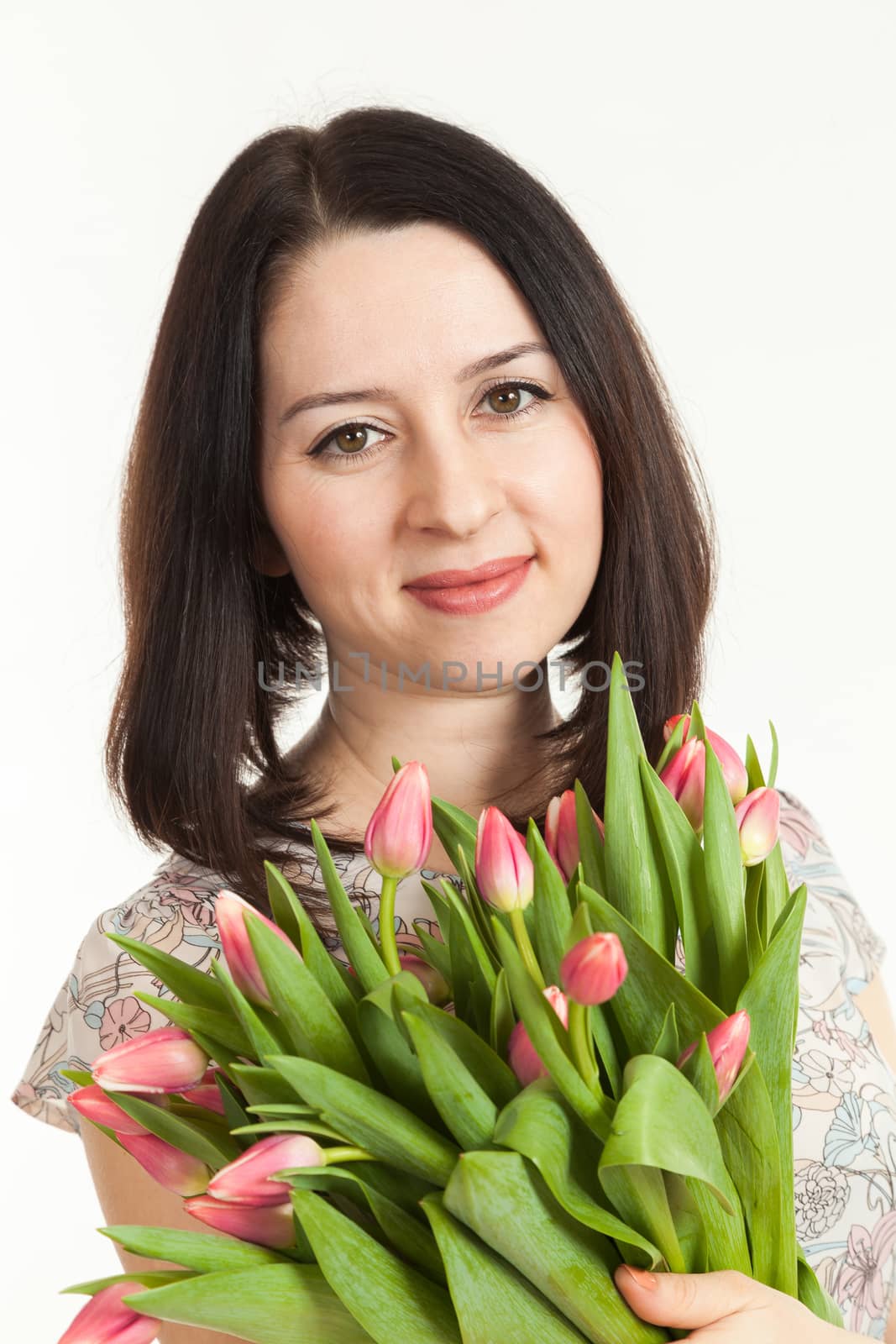 the beautiful woman holds a bouquet of tulips