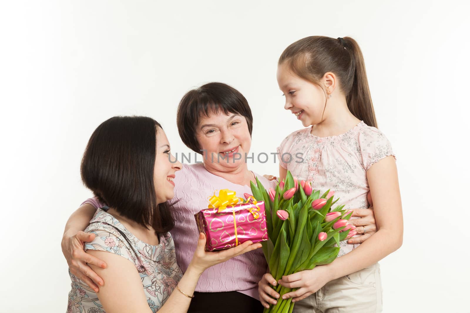 the daughter and the granddaughter give a bouquet  by sveter
