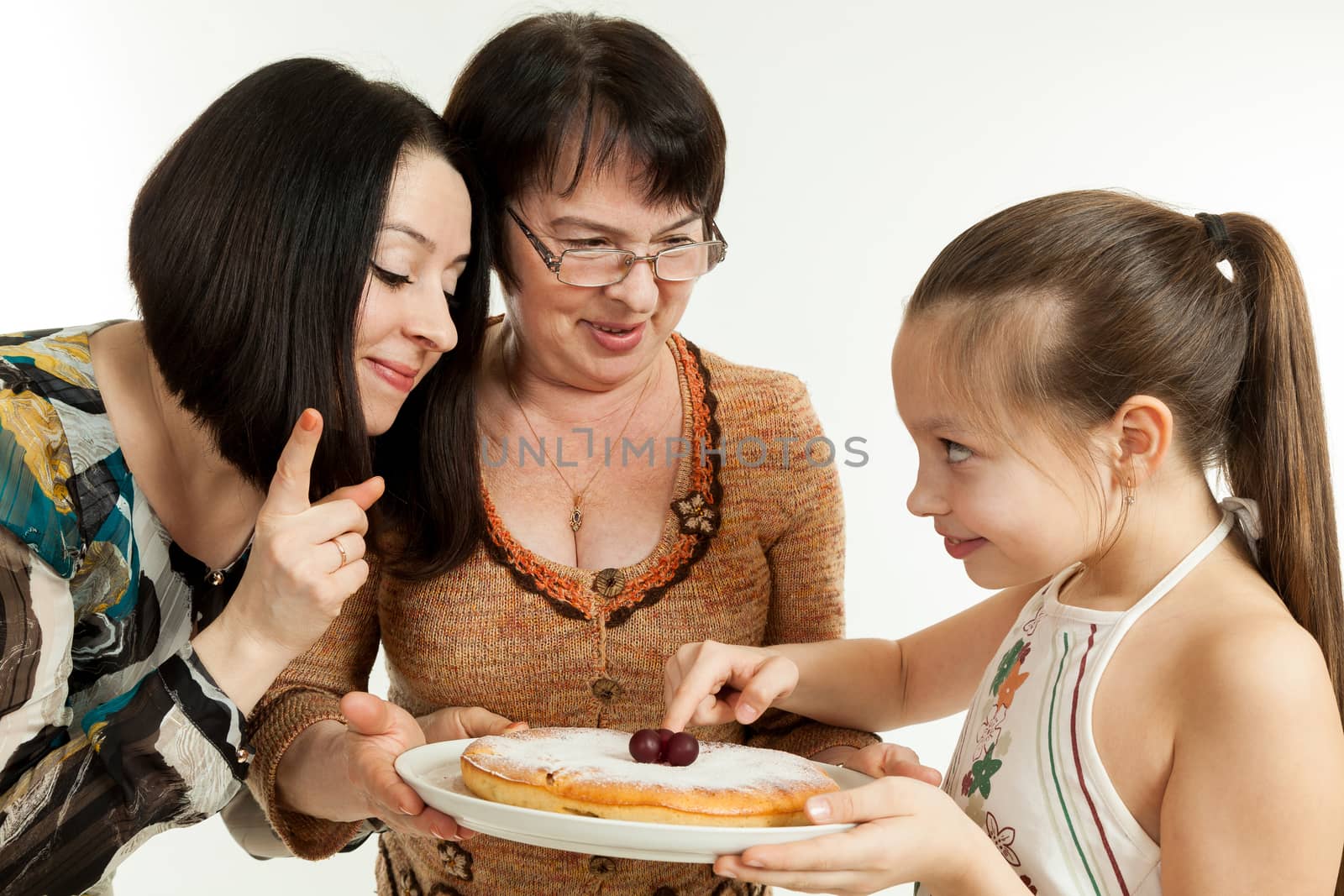 the grandmother holds the pie made for the daughter and the granddaughter